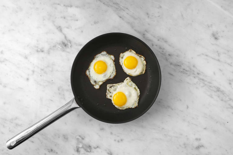 Fry the eggs and bake the buns