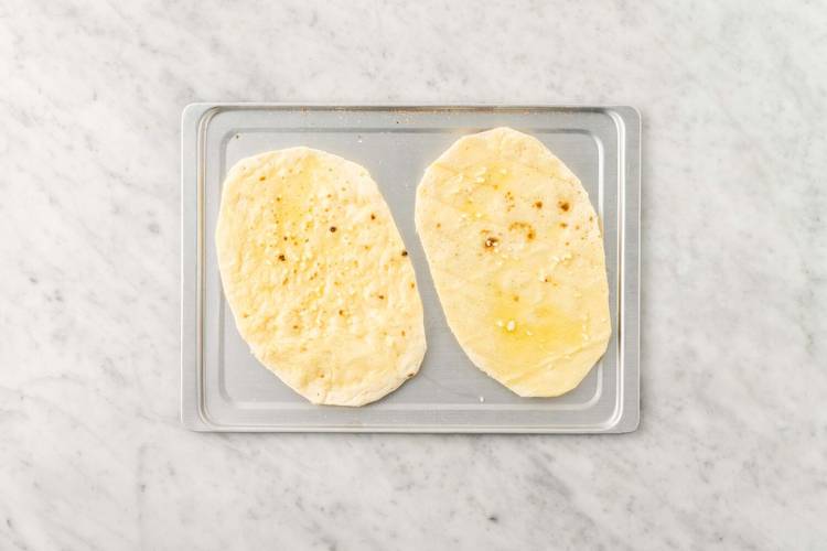 Warm flatbreads and melt butter