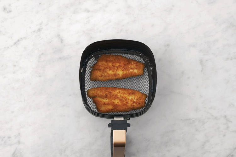 Cook the crumbed basa