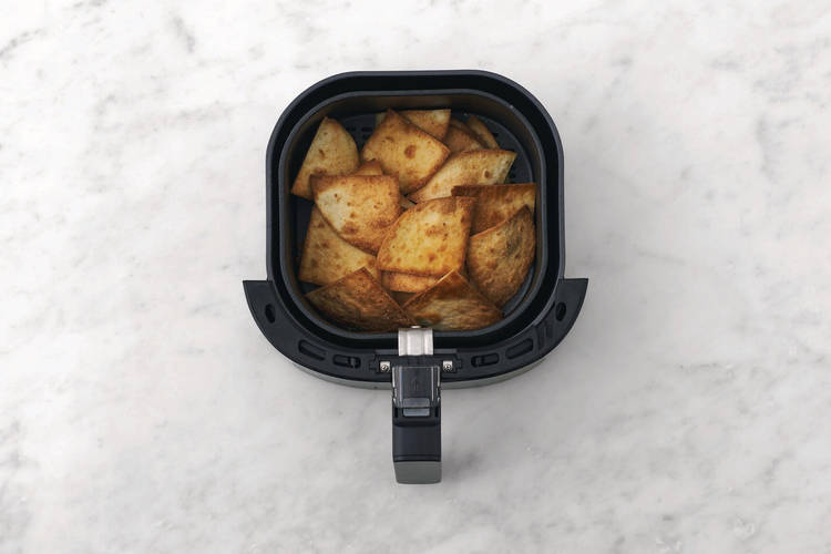 Cook the nacho chips 