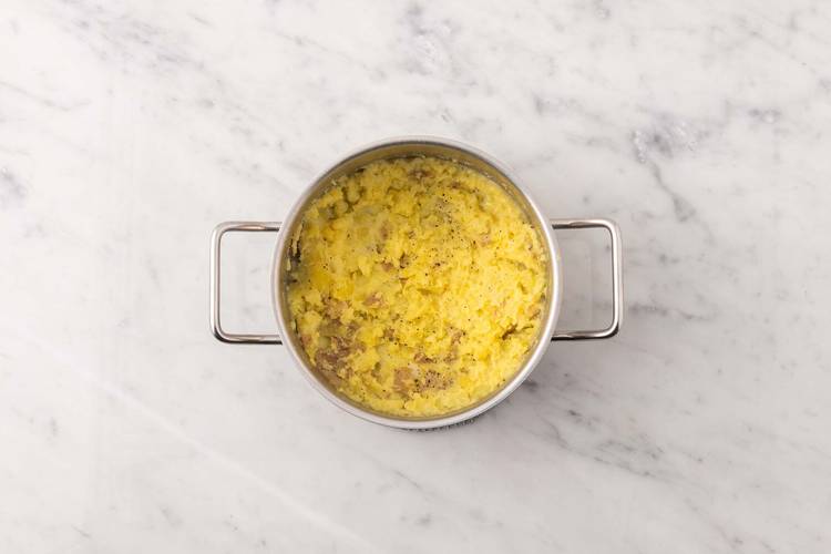 Écraser les pommes de terre et fondre le beurre à l’ail