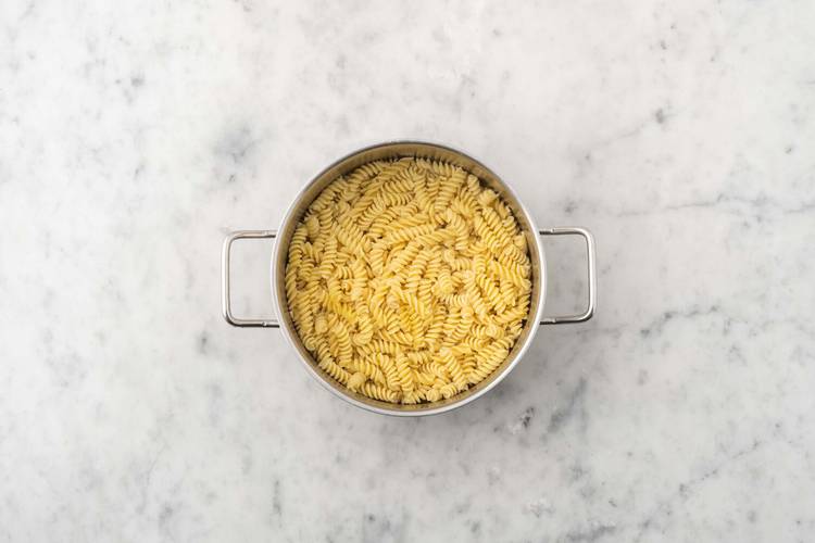 Cook fusilli and sausage