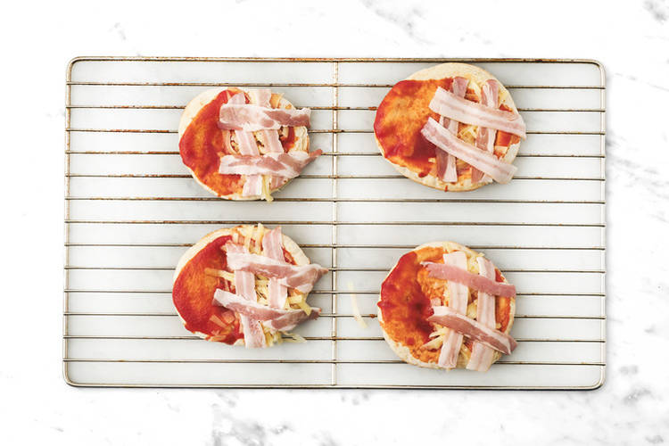 Assemble the ‘mummy’ pizzas 