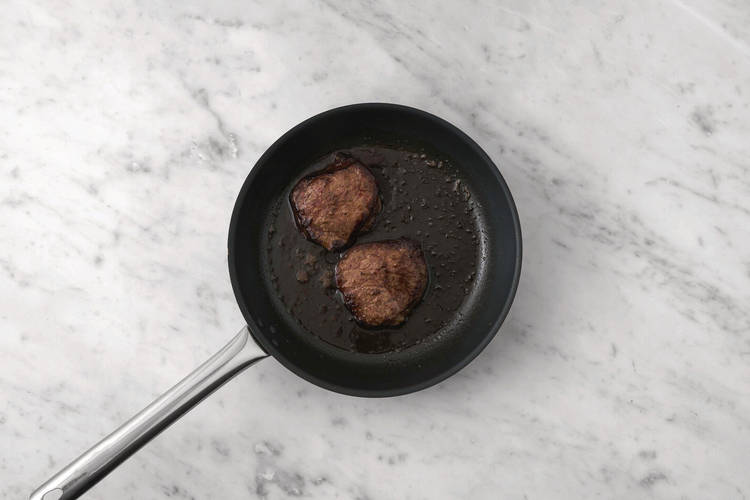 Cook the steak and prawns