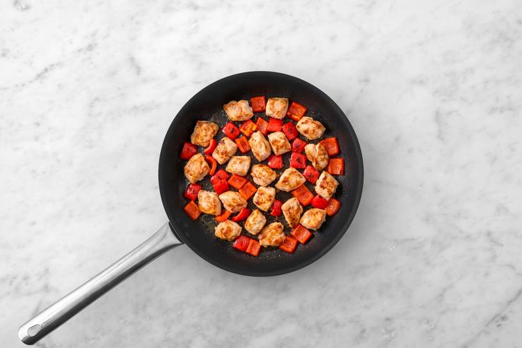 Cook chicken and peppers