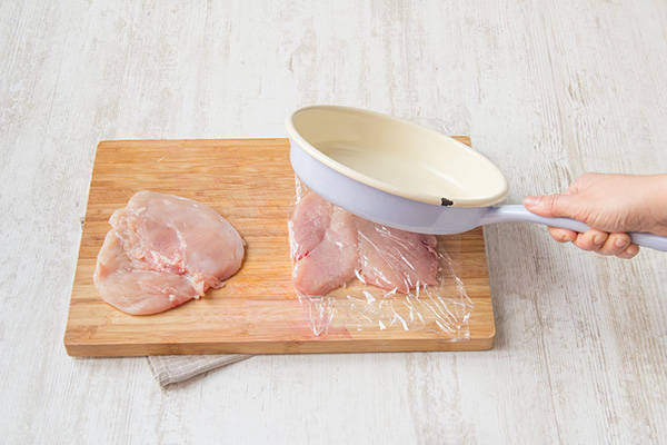 Pound with a mallet or large pan