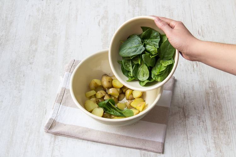 Dress the spinach and potatoes