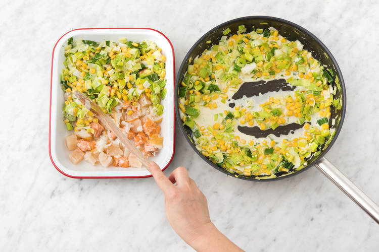 Spoon veggies on top of fish mix.