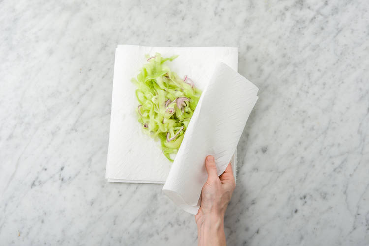 Squeeze moisture out of cucumber.