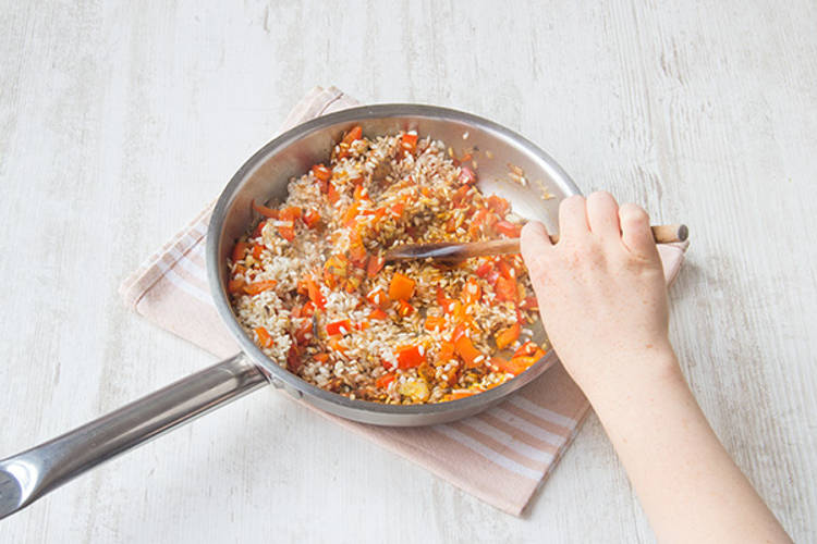 Add arborio rice to veggies.