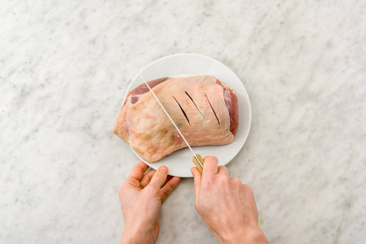Make 10 x 1 cm-deep cuts all over the lamb leg portion