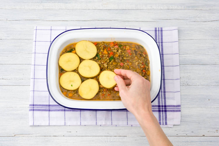 Lay potato slices over lentil mixture.