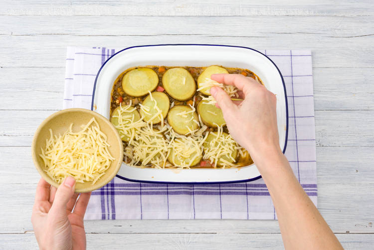 Scatter cheese over hot pot.