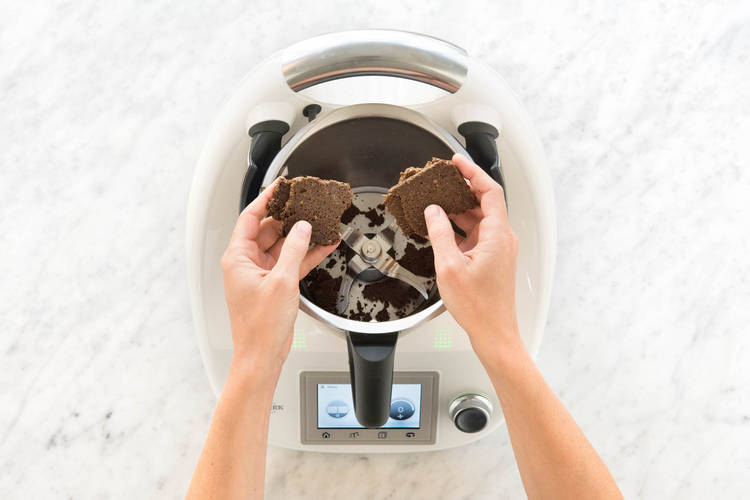 Pumpernickel mit den Händen grob zerkleinern