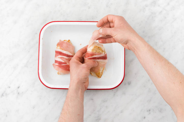 Wrap the strips of middle bacon around the chicken breast
