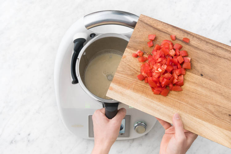Tomatenwürfe in den Mixtopf hinzugeben