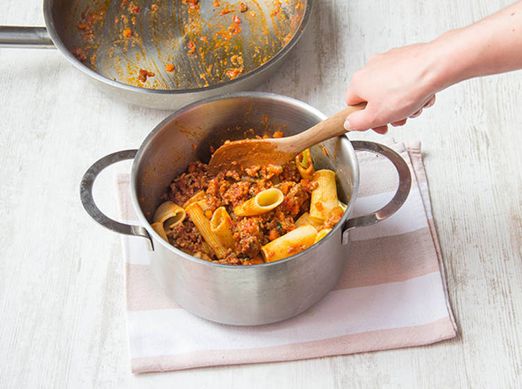 Stir the Bolognese sauce through the rigatoni