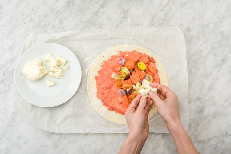 Tear mozzarella over pizza.