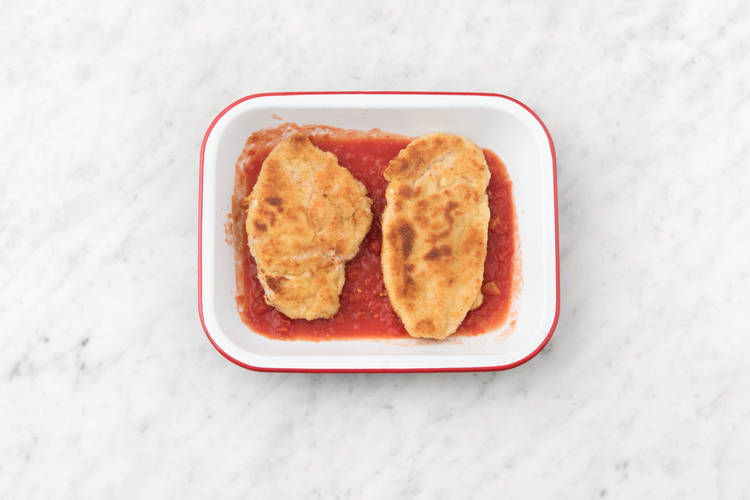 Place the diced tomatoes and chicken in the ovenproof dish