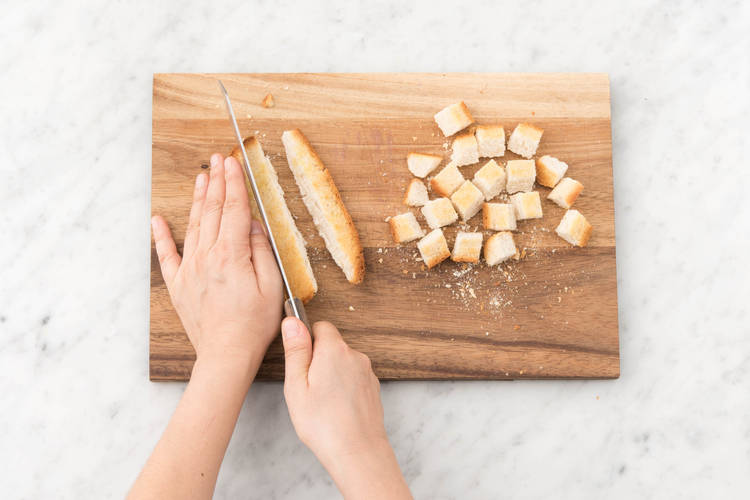Slice the sourdough roll into 1 cm cubes