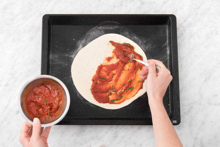 Spread the sauce onto your pizza bases