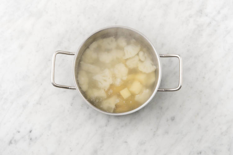Boil potatoes and cauliflower