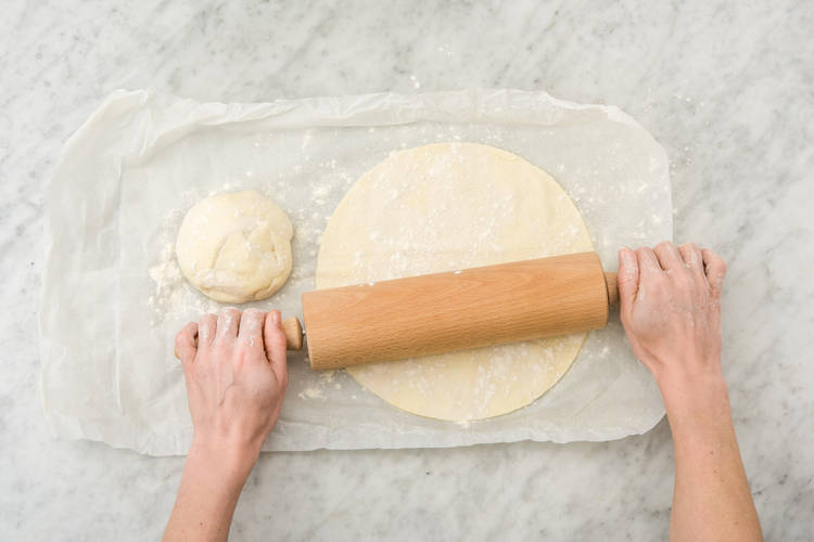 Roll pizzas.