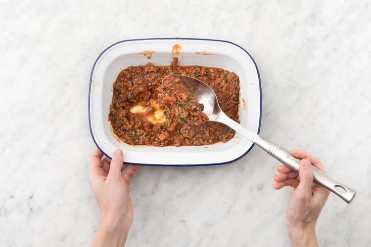 Spoon half of the mince mixture into the base of a medium baking dish