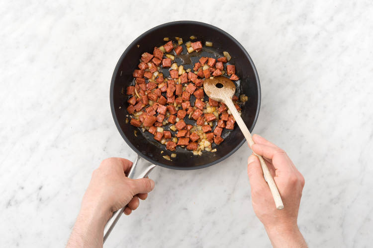 Simmer chorizo, onion and spices.