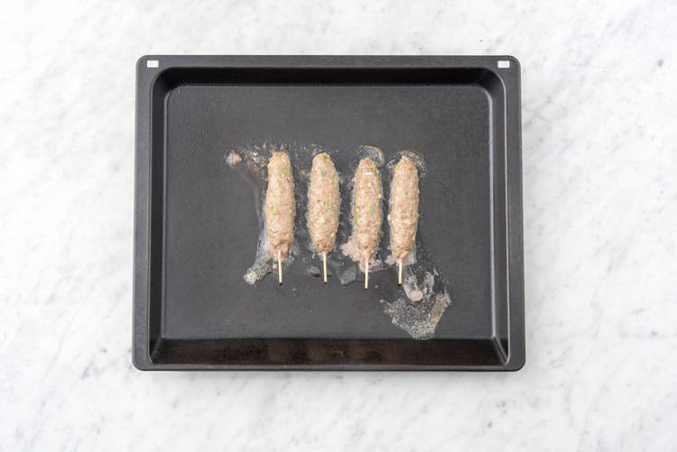 Squeeze meat onto skewers