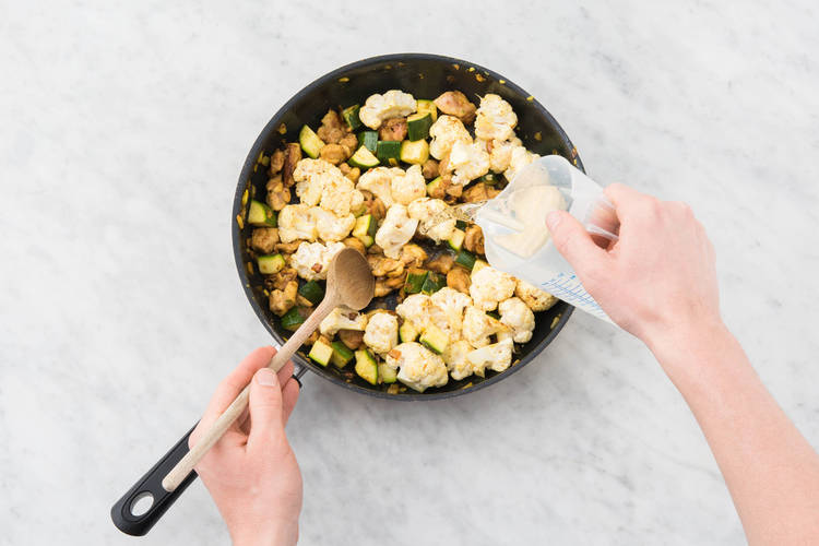 Add the broth concentrate(s), zucchini, cauliflower and 21/2 cups water